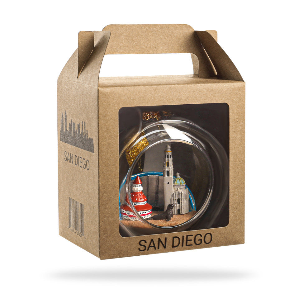 Decorative item in a clear ball with a cityscape inside, displayed in a 'San Diego' branded box.