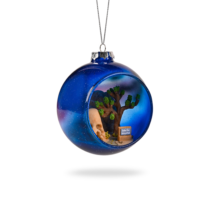 Joshua Tree National Park Glass Globe Ornament by Local Elves featuring Skull Rock and Milky Way night sky from the side
