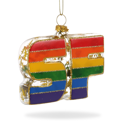 Hand-painted glass ornament in the shape of 'SF' with rainbow stripes and glitter accents, hanging from a thread.