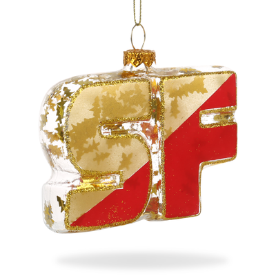 Hand-painted glass ornament in the shape of 'SF' with red and gold colors and glitter accents, hanging from a gold loop.