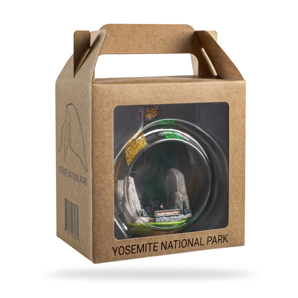 Cardboard packaging with a clear window displaying a Yosemite National Park-themed product on a white background.